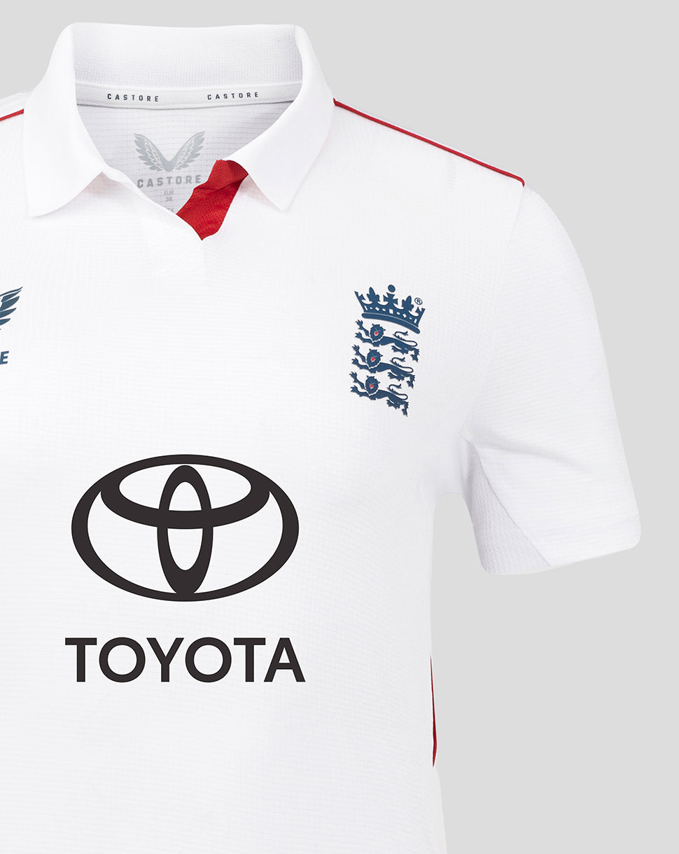 Close up of chest area showing crest on left and Toyota logo on white England cricket shirt