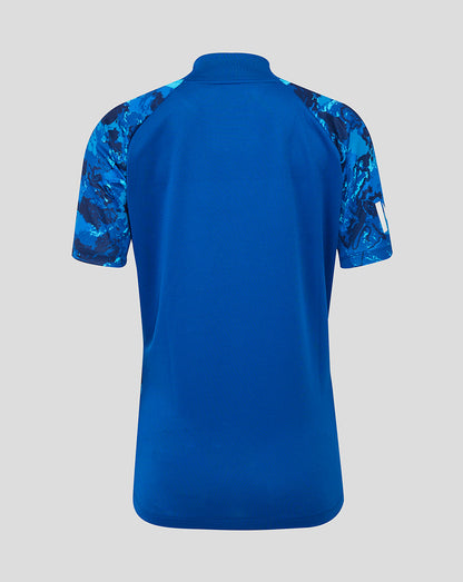 Back view of England ODI women's short sleeve cricket shirt in blue camouflage with solid back panel and raglan sleeves.