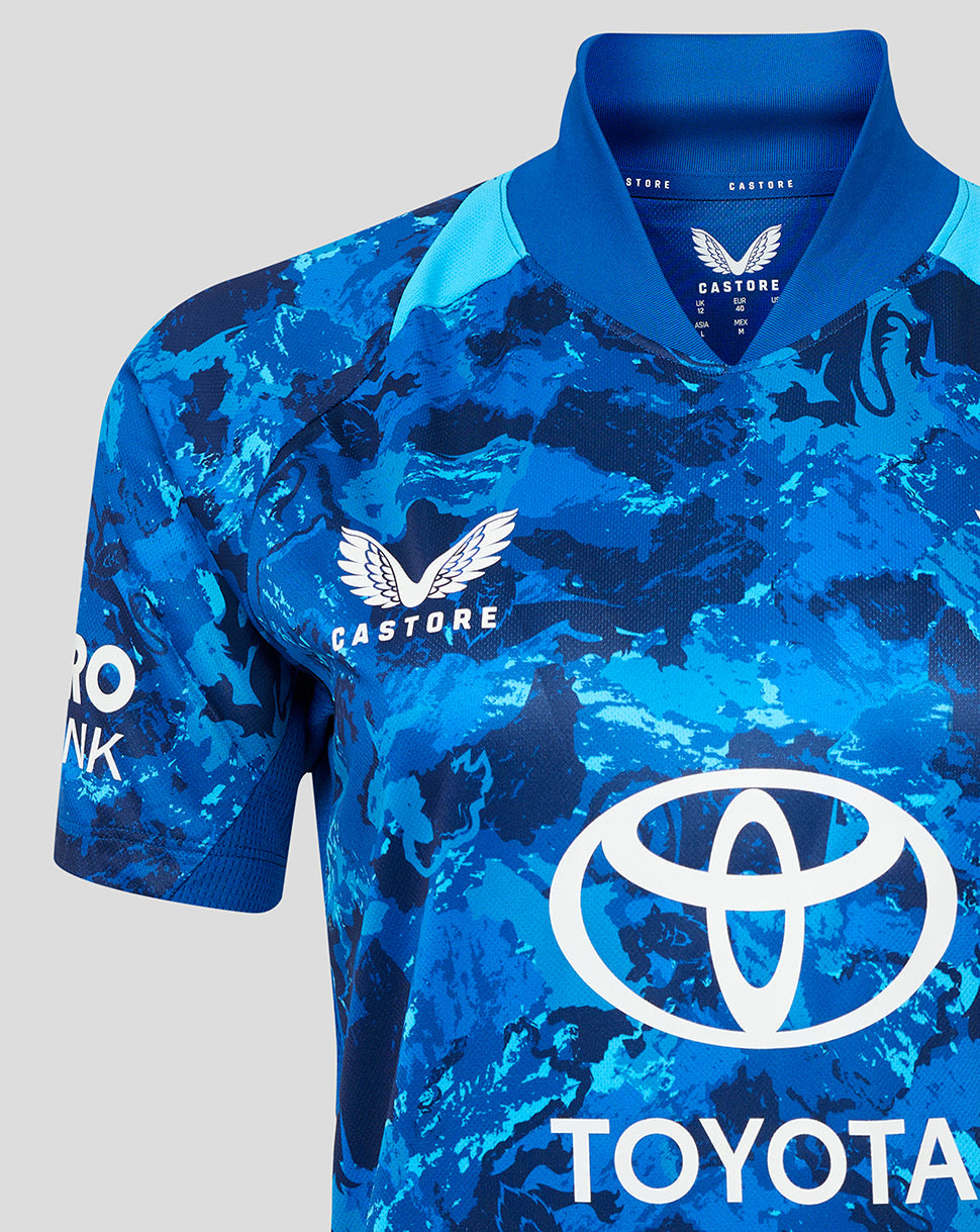 Close-up of England ODI Women's Short Sleeve Shirt in blue camouflage with Three Lions crest on the left chest and Toyota sponsor logo across the front.