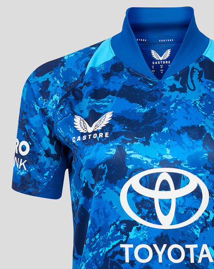 Close-up of England ODI Women's Short Sleeve Shirt in blue camouflage with Three Lions crest on the left chest and Toyota sponsor logo across the front.