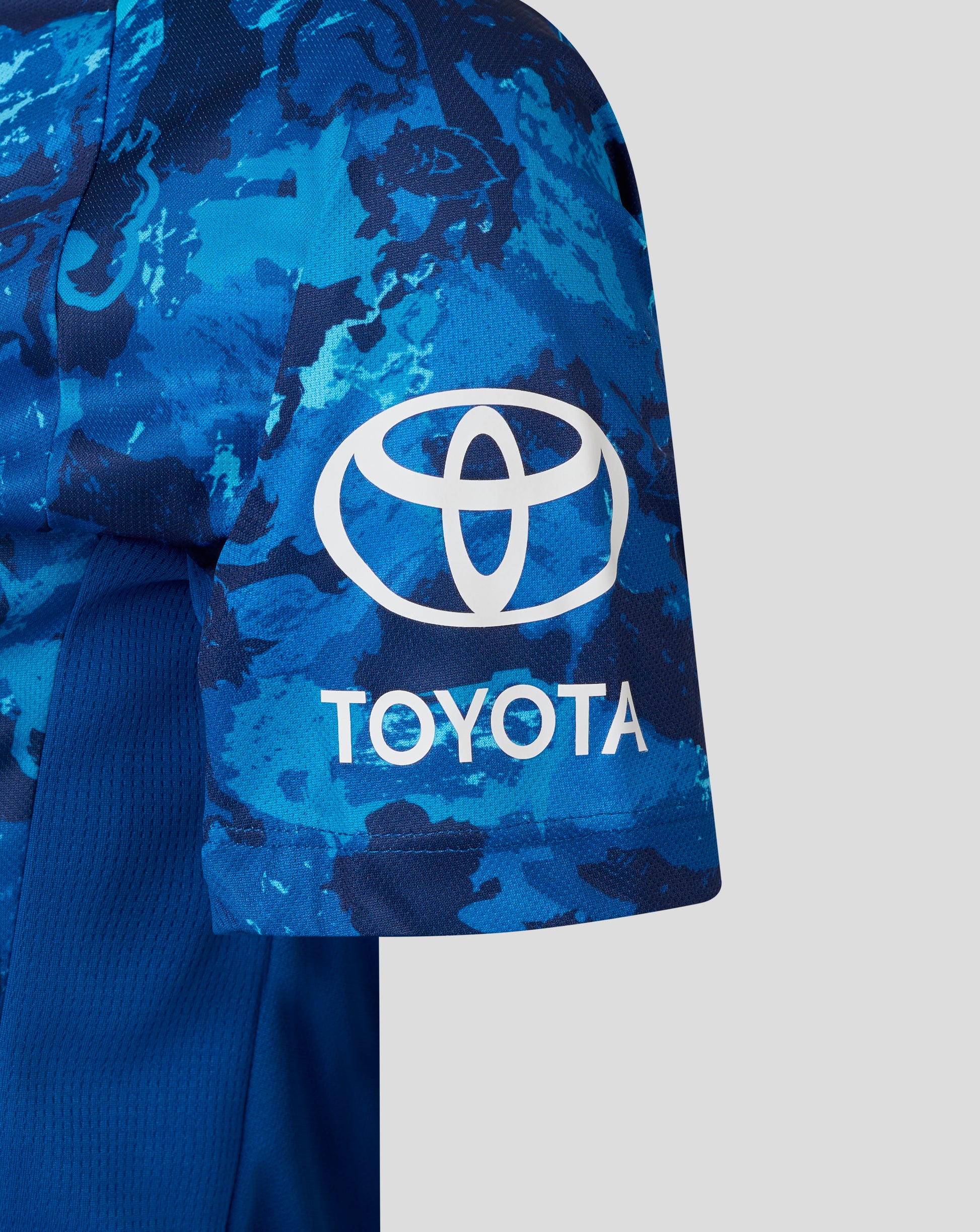 Close up of a blue camouflage England women's ODI World Cup replica shirt with a white Toyota logo on the sleeve
