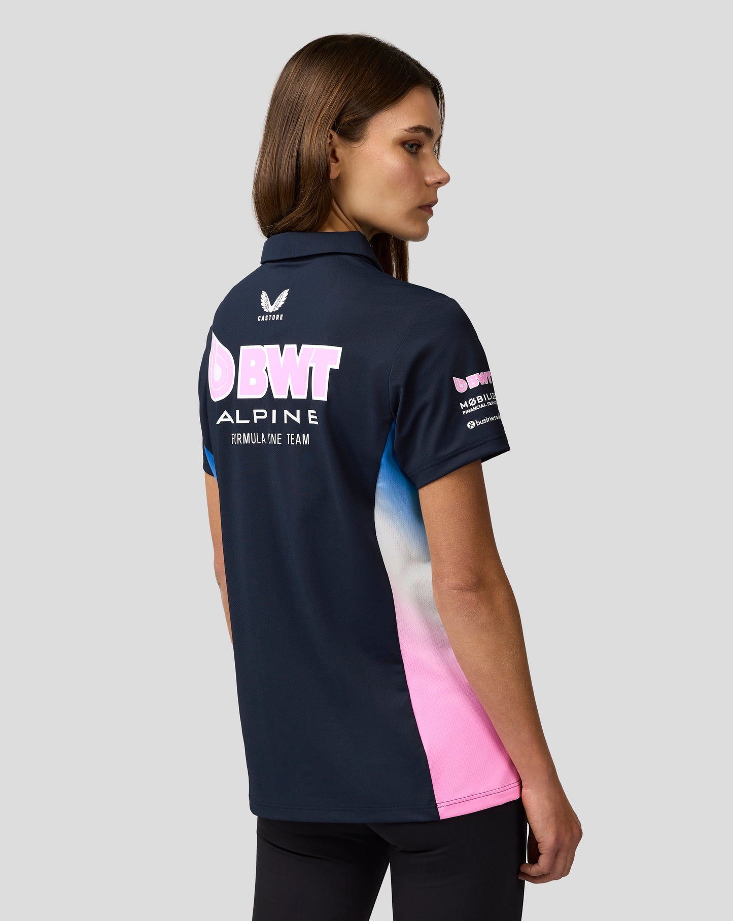 Back view of navy BWT Alpine polo with pink side panel and sponsor logos along the back