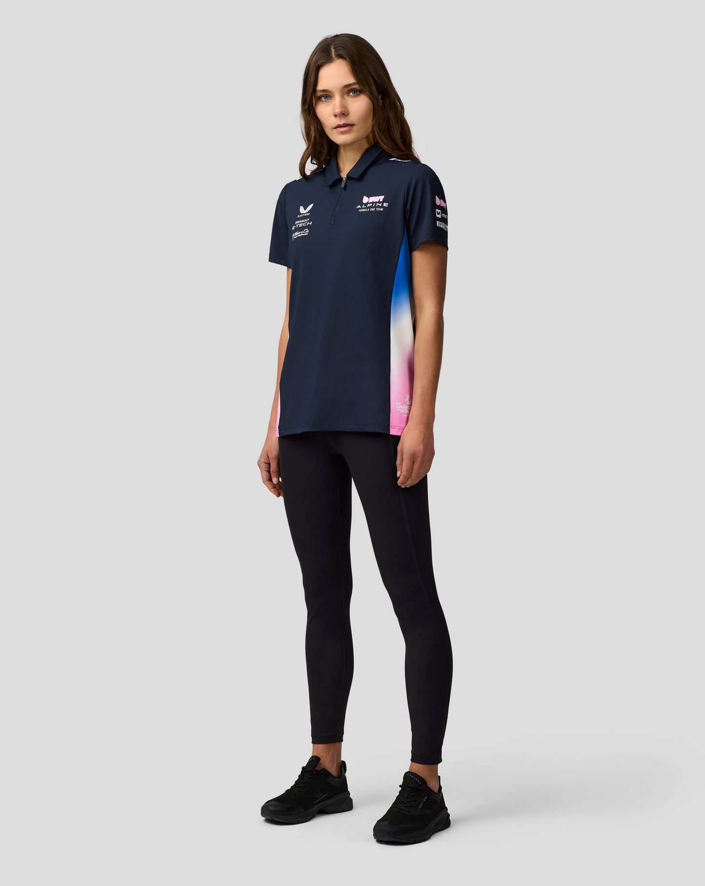 Model wearing navy BWT Alpine Formula One Team polo with center front zip and chest logos