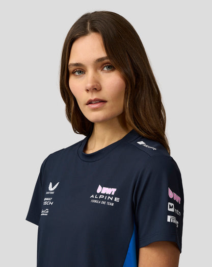 Profile view of a woman wearing navy BWT Alpine Set Up T Shirt showing team branding on the shoulder.