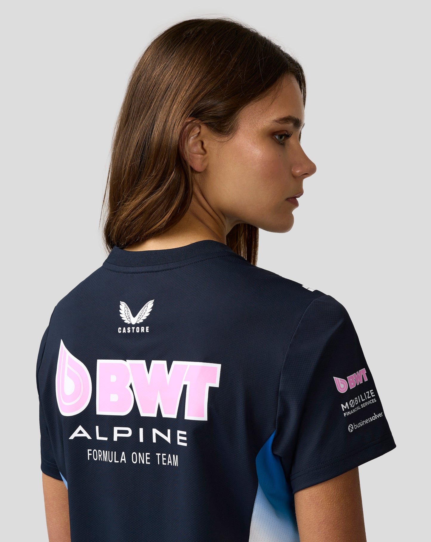 Side view of navy BWT Alpine Set Up T Shirt with large pink BWT logo across the front.