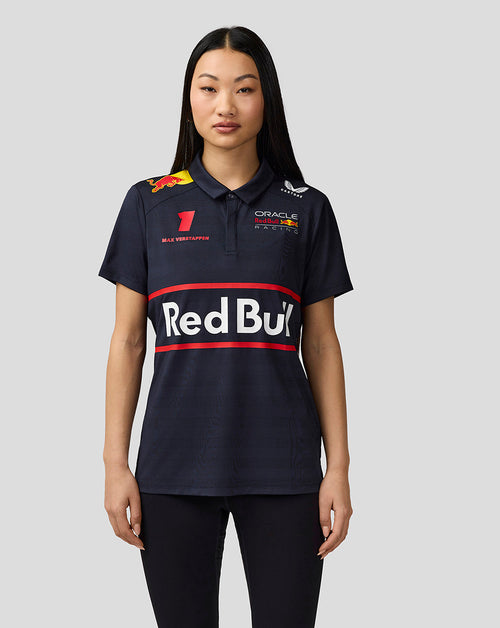 Front view of a woman wearing a navy Oracle Red Bull Racing polo with bold Red Bull graphics.
