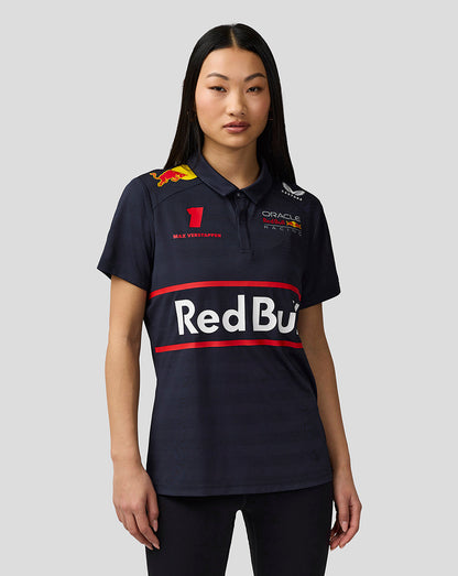 Model wearing navy night sky Oracle Red Bull Racing Teamline polo with large Red Bull logo and Verstappen graphics