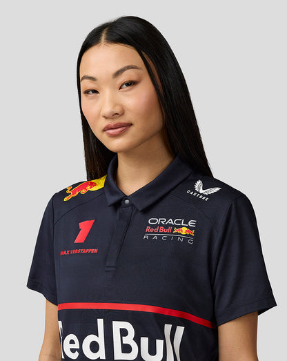 Close up of model in navy night sky teamline polo showing Verstappen artwork and Red Bull branding