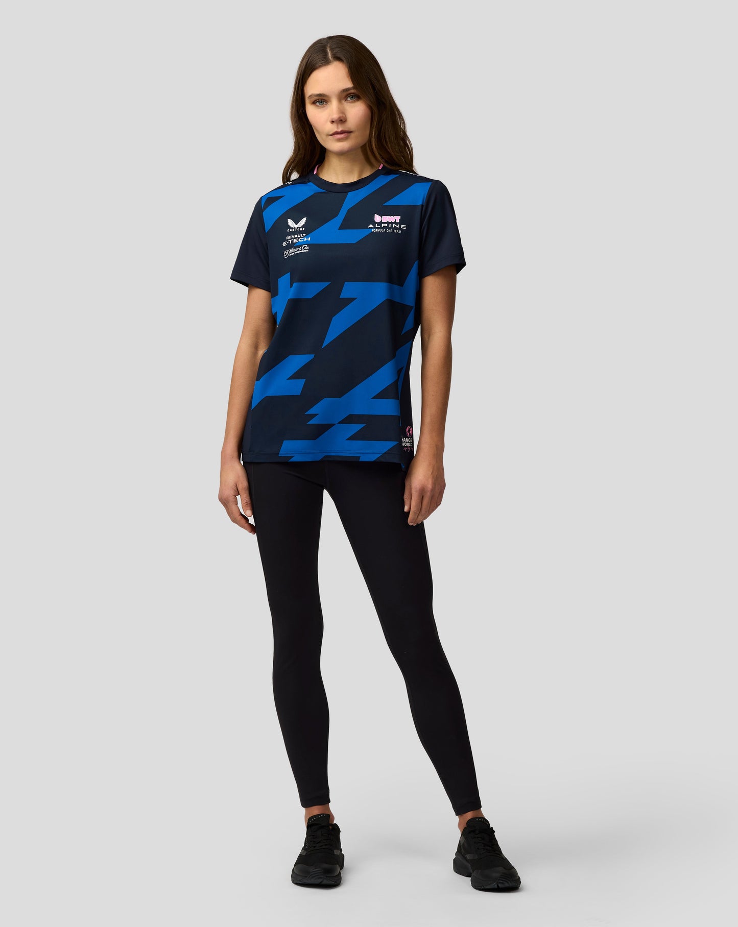 Front three-quarter view of a woman in navy Alpine F1 Team Jack Doohan jersey with blue geometric pattern and sponsor logos