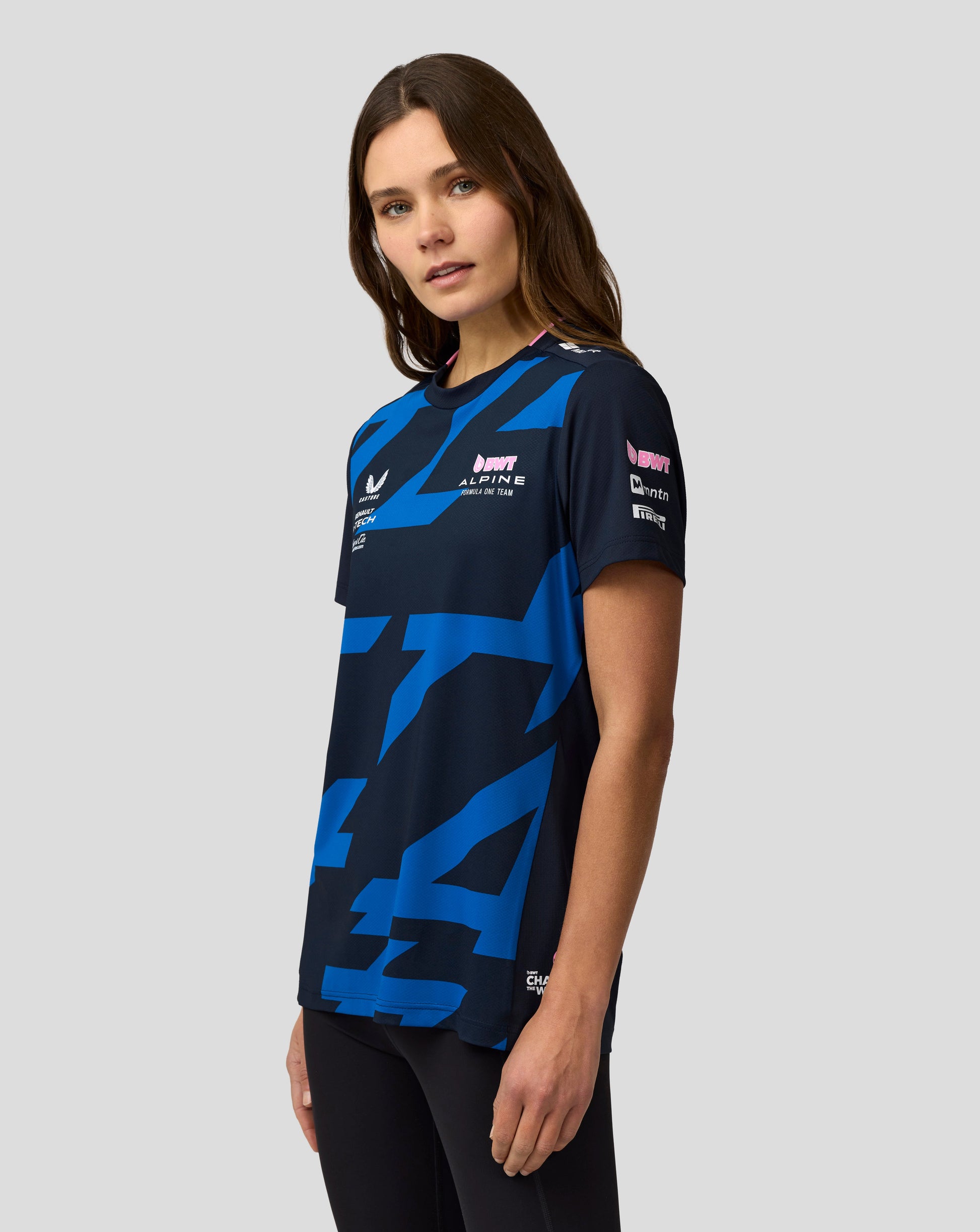 Female model wearing navy Alpine Formula One Team Jack Doohan jersey with blue print and pink trim.