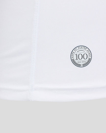 Close-up of the lower side of the shirt displaying a circular 100th anniversary badge.