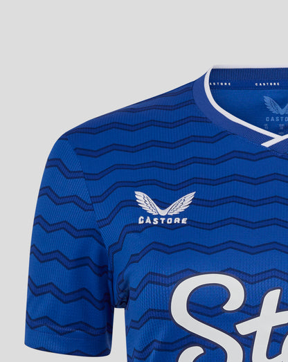 Close up of blue Everton FC women's home shirt with wavy chevron pattern, white neck trim, and Castore branding.
