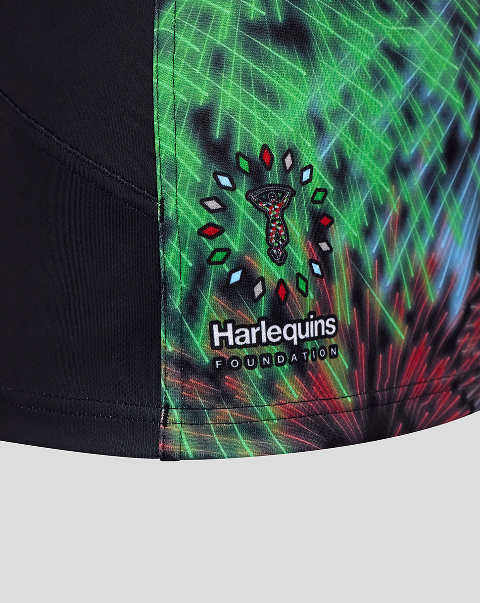 Harlequins Pro Shirt close up showing the Harlequins Foundation crest on a bright neon pattern.