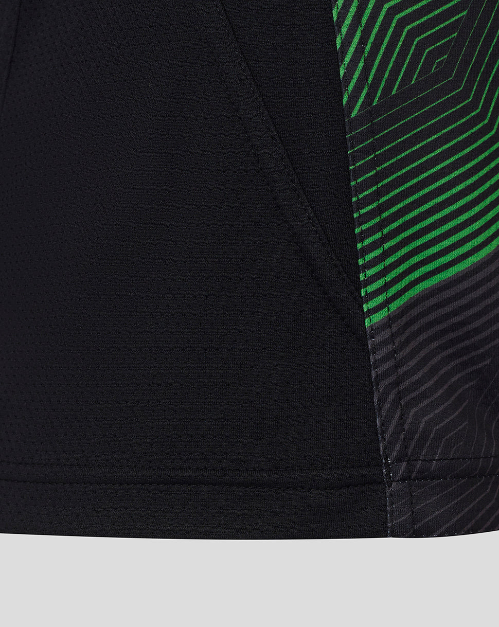 Close-up of side seam on Harlequins matchday tee showing black fabric with bright green diagonal stripe pattern