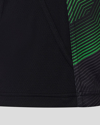 Close-up of side seam on Harlequins matchday tee showing black fabric with bright green diagonal stripe pattern