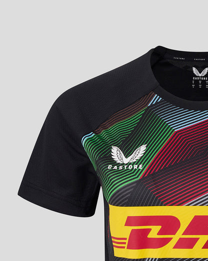 Close up of Harlequins matchday short sleeve tee with bold multicolor diagonal graphic and yellow DHL sponsor panel on black fabric