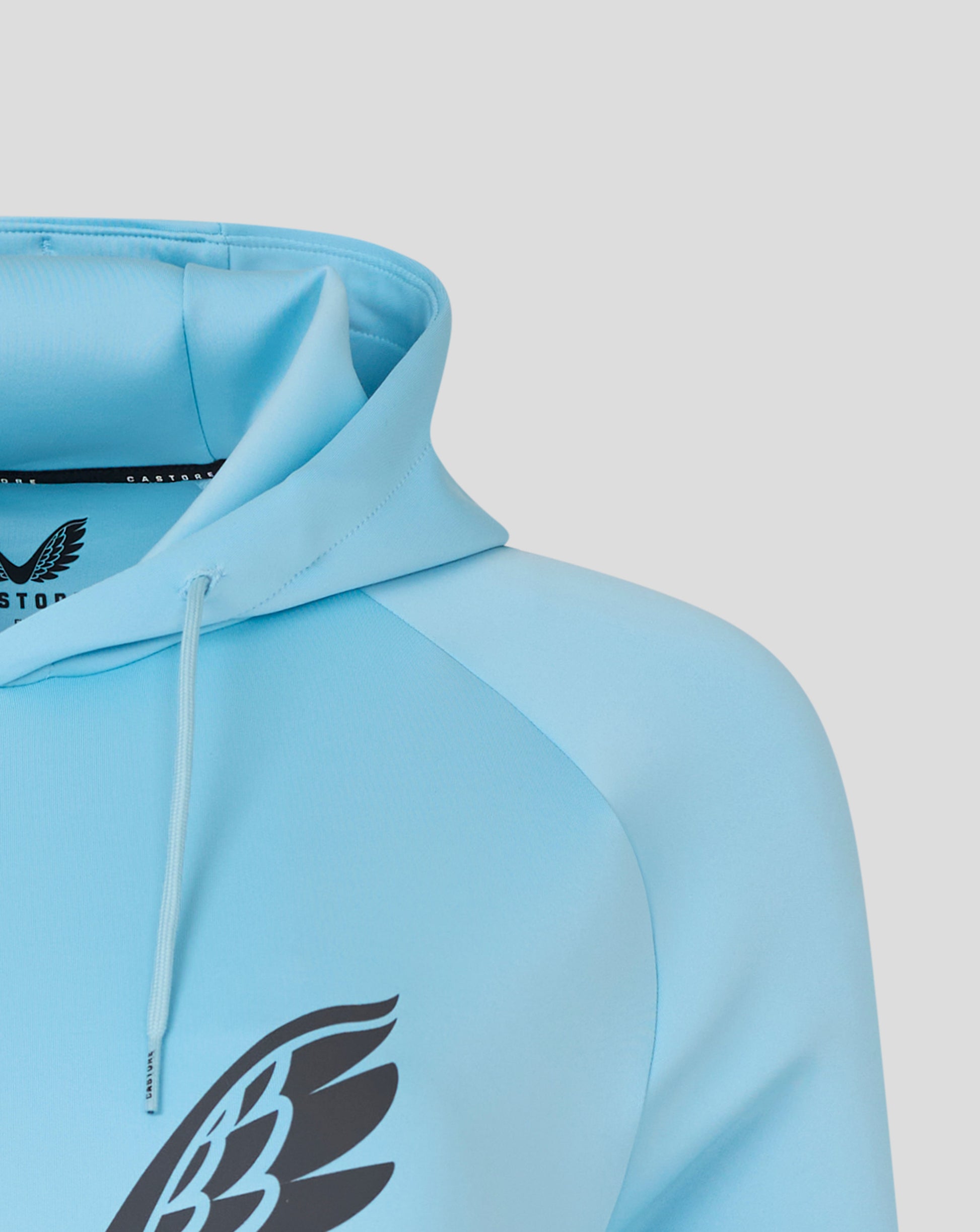 Partial view of bold black emblem on the front of a light blue Harlequins hoodie