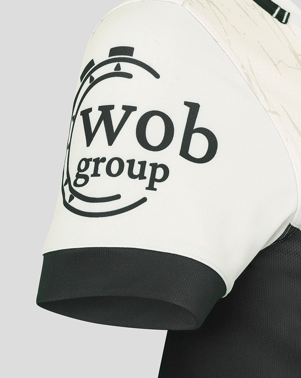Close-up of the Saracens Away Pro Shirt sleeve showing a bold black circular logo on white fabric.