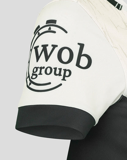 Close-up of the Saracens Away Pro Shirt sleeve showing a bold black circular logo on white fabric.