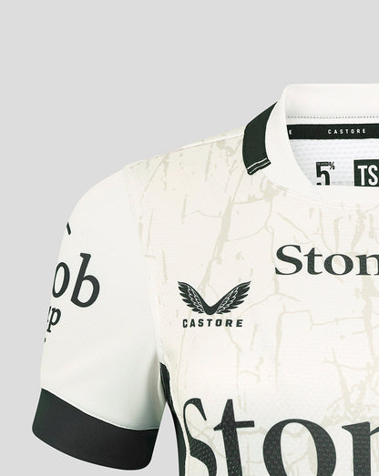 Left chest view of white Saracens Away Pro Shirt featuring crest Castore branding and beige marbled pattern