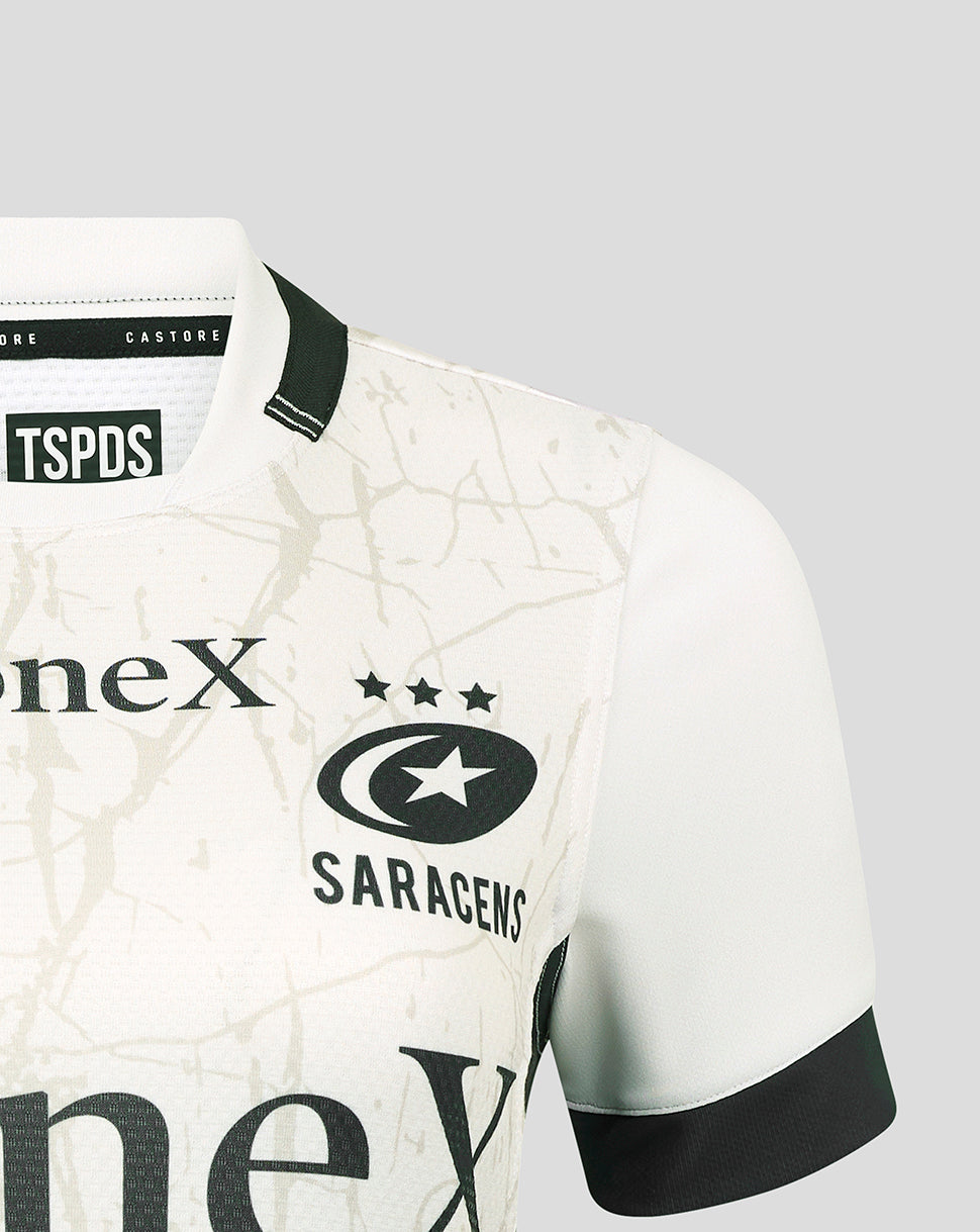 Close up of white Saracens Away Pro Shirt shoulder with black trim beige marbled pattern and Saracens crest