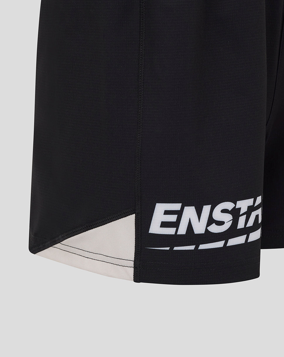 Close up of black Saracens shorts showing hem with white graphic print and beige underlay panel