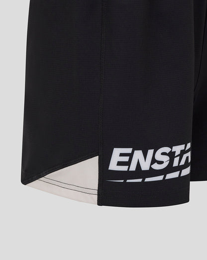 Close up of black Saracens shorts showing hem with white graphic print and beige underlay panel
