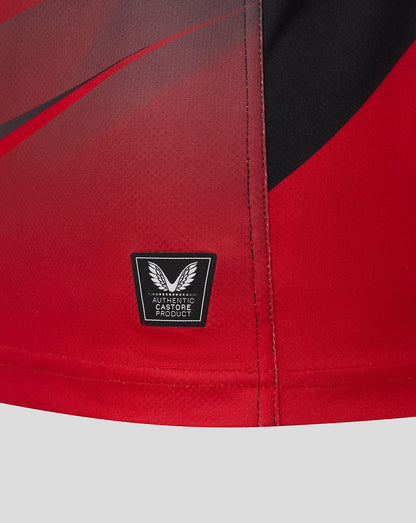 Close-up of the red and black gradient hem on the Saracens replica shirt with authentic Castore product badge