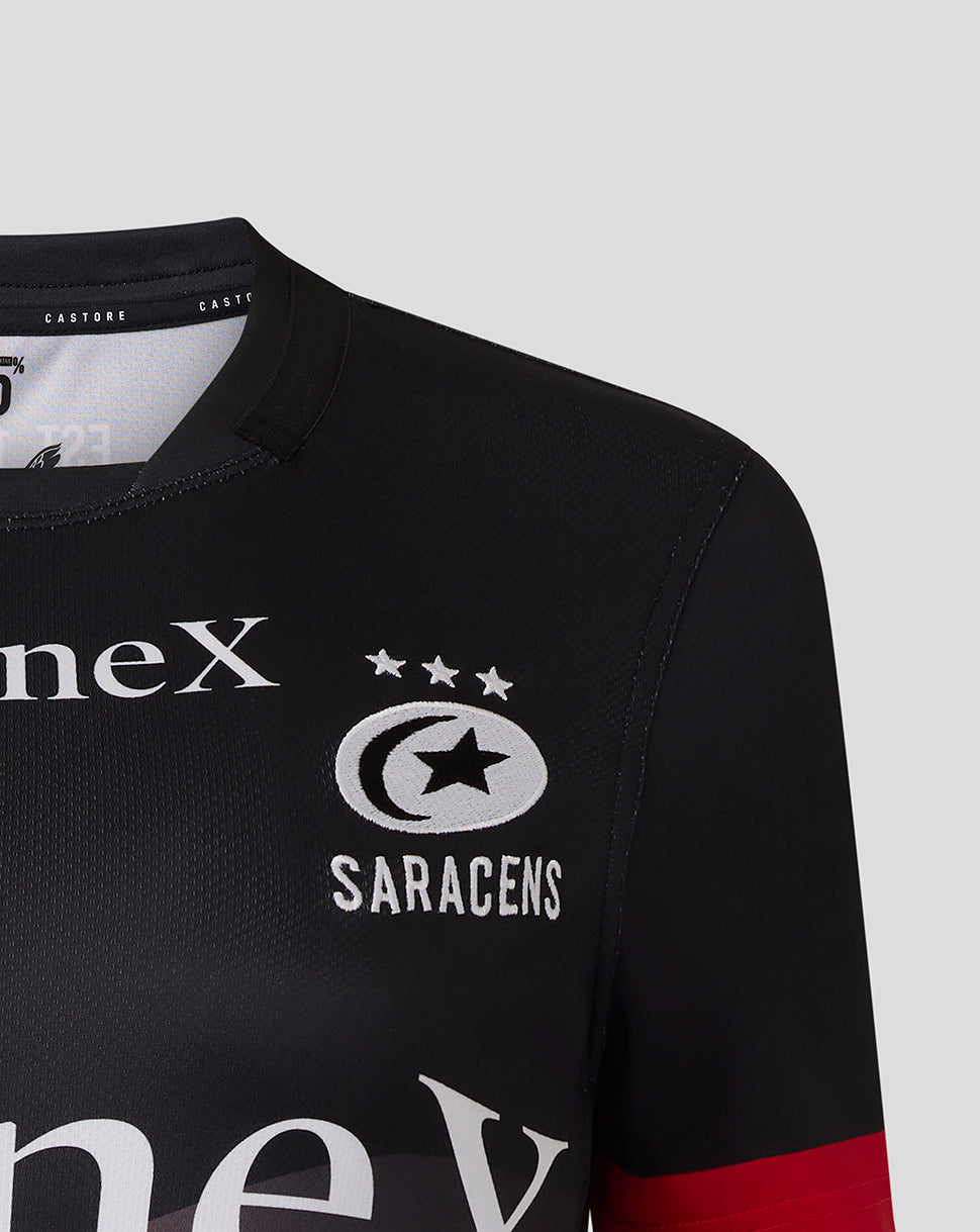 Chest area of the Saracens replica shirt showing crest and StoneX branding on black fabric
