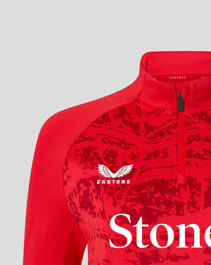 Close-up of red Saracens midlayer top showing StoneX sponsor logo and Castore branding