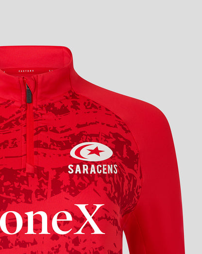 Red Saracens pre match midlayer top with white Saracens logo and bold abstract print inspired by Take Flight