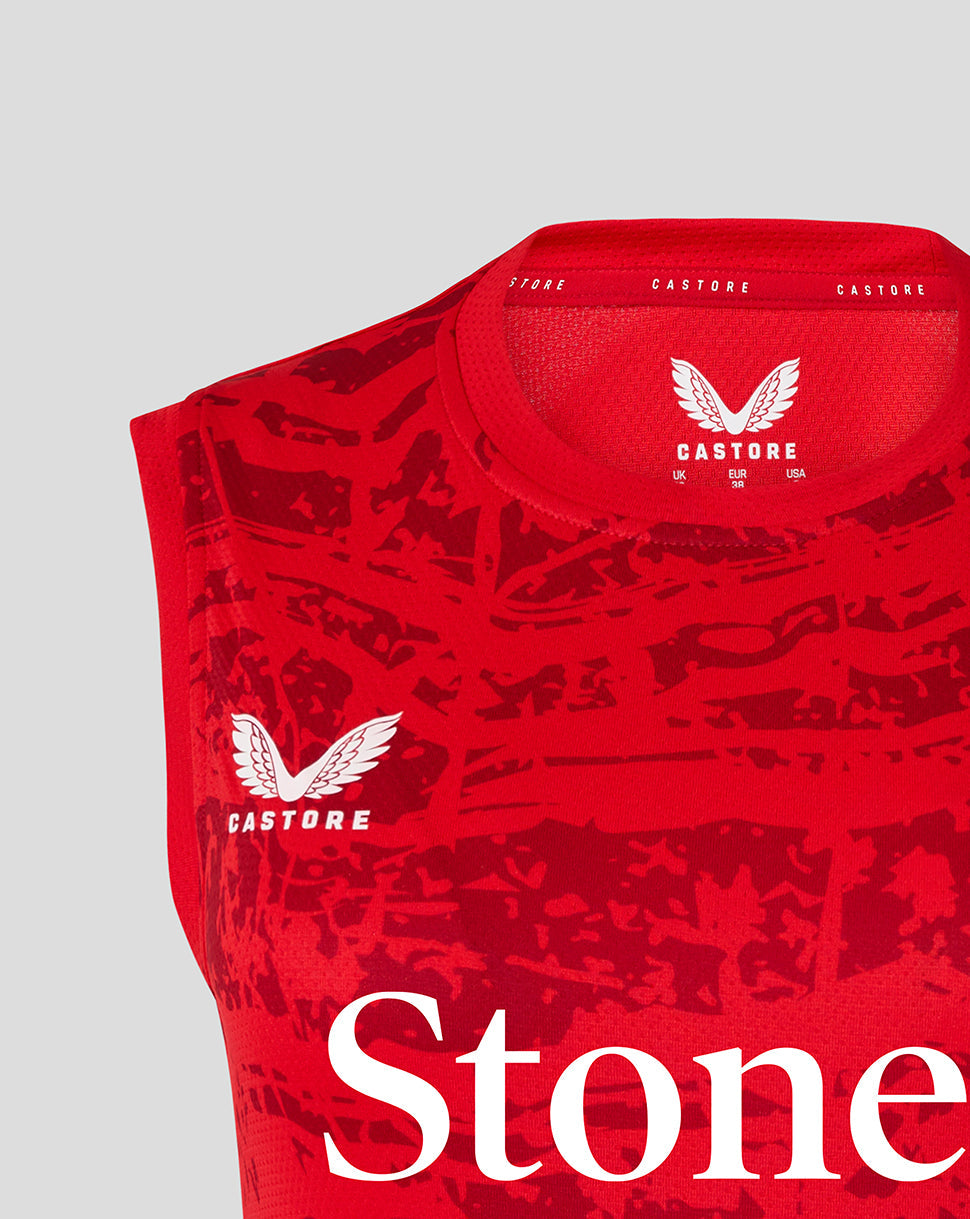 Close up of the red sleeveless tee neckline showing Castore branding and size label inside