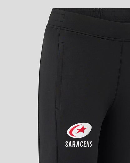 Close-up of black Saracens training pants with a white Saracens logo on the thigh