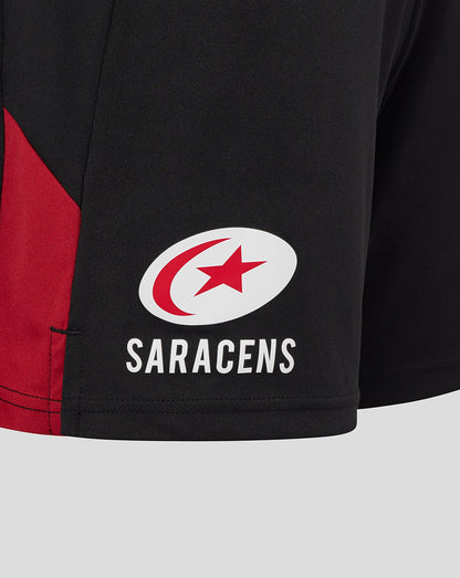 Close up of Saracens logo on black training shorts thigh.