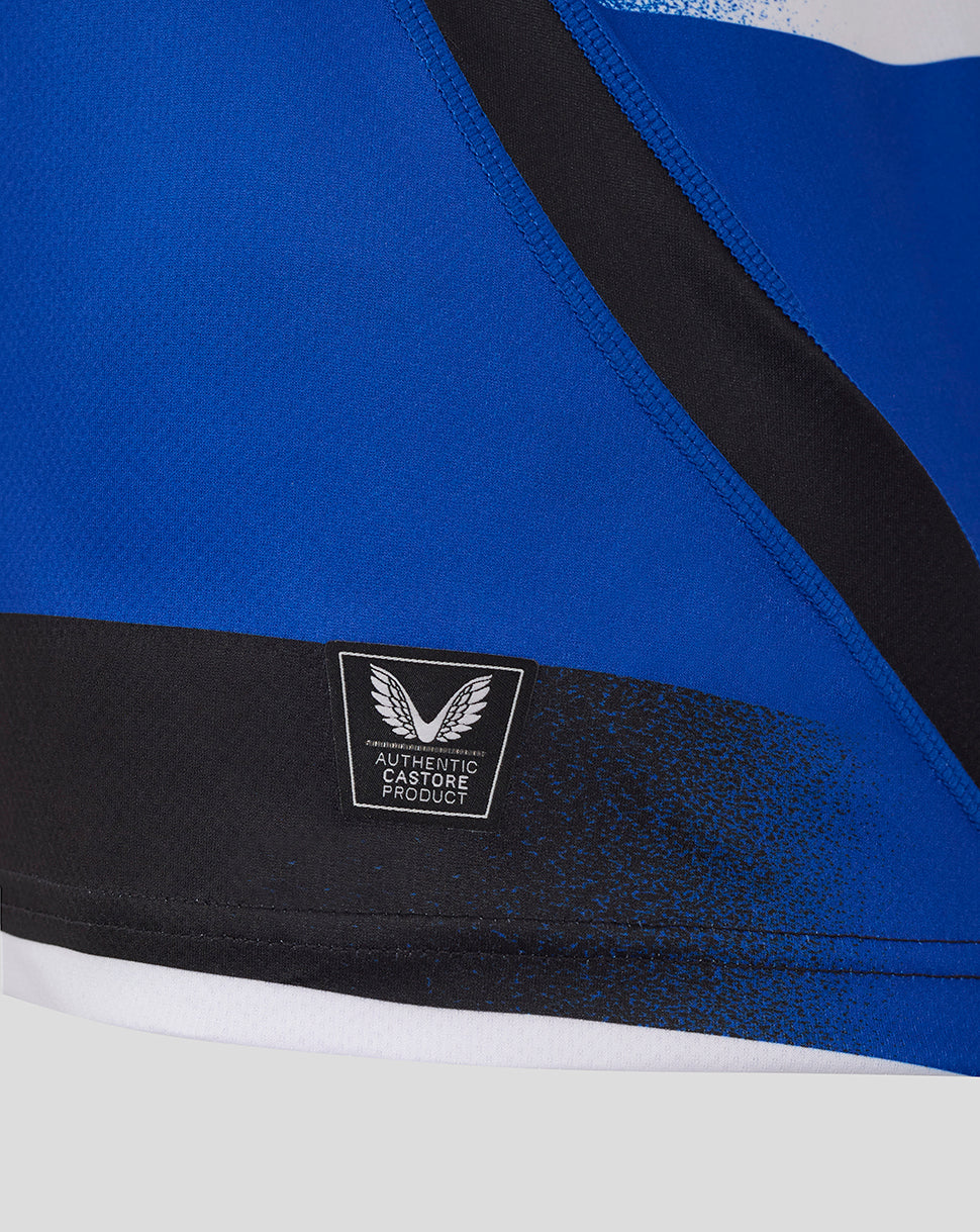 Close up of blue Bath Rugby shirt with black stripe and authentic Castore product patch at the hem