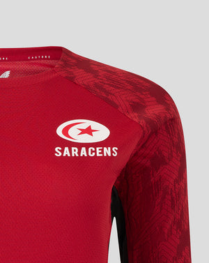 Close-up of upper chest and shoulder on red Saracens training long sleeve tee showing shoulder panel pattern and chest logo
