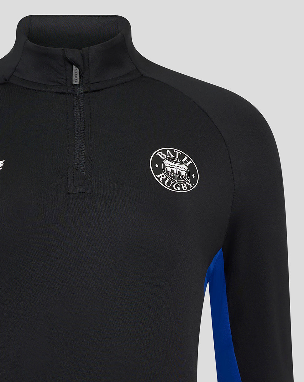 Close-up of the black Bath Rugby midlayer showing a zip placket at the neck and circular Bath Rugby crest on the chest