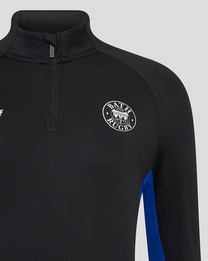 Close-up of the black Bath Rugby midlayer showing a zip placket at the neck and circular Bath Rugby crest on the chest