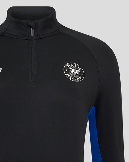 Close-up of the black Bath Rugby midlayer showing a zip placket at the neck and circular Bath Rugby crest on the chest