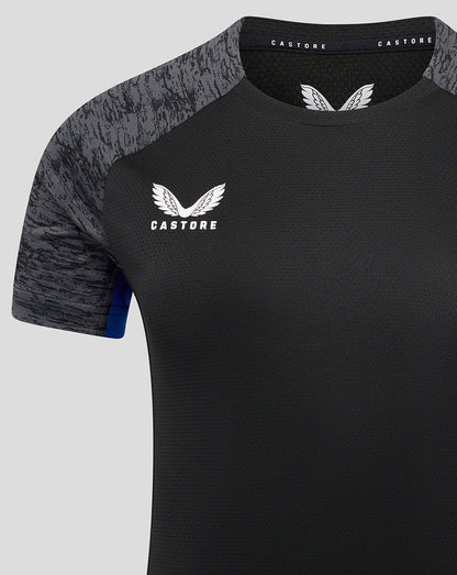 Close-up of chest area showing Castore logo and Bath Rugby crest on black training tee with grey patterned sleeves
