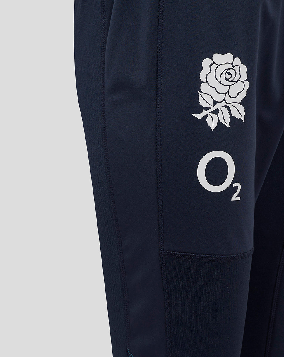 Close-up of navy drill pants showing rose crest and O2 logo on the thigh.