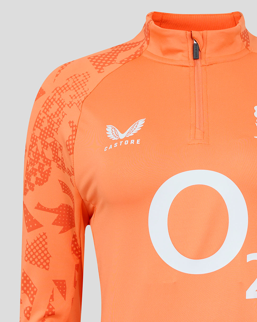 Orange England Rugby Women's performance midlayer top close up showing O2 center branding, rose crest on the chest and Castore logo on the opposite chest with abstract side panel print.