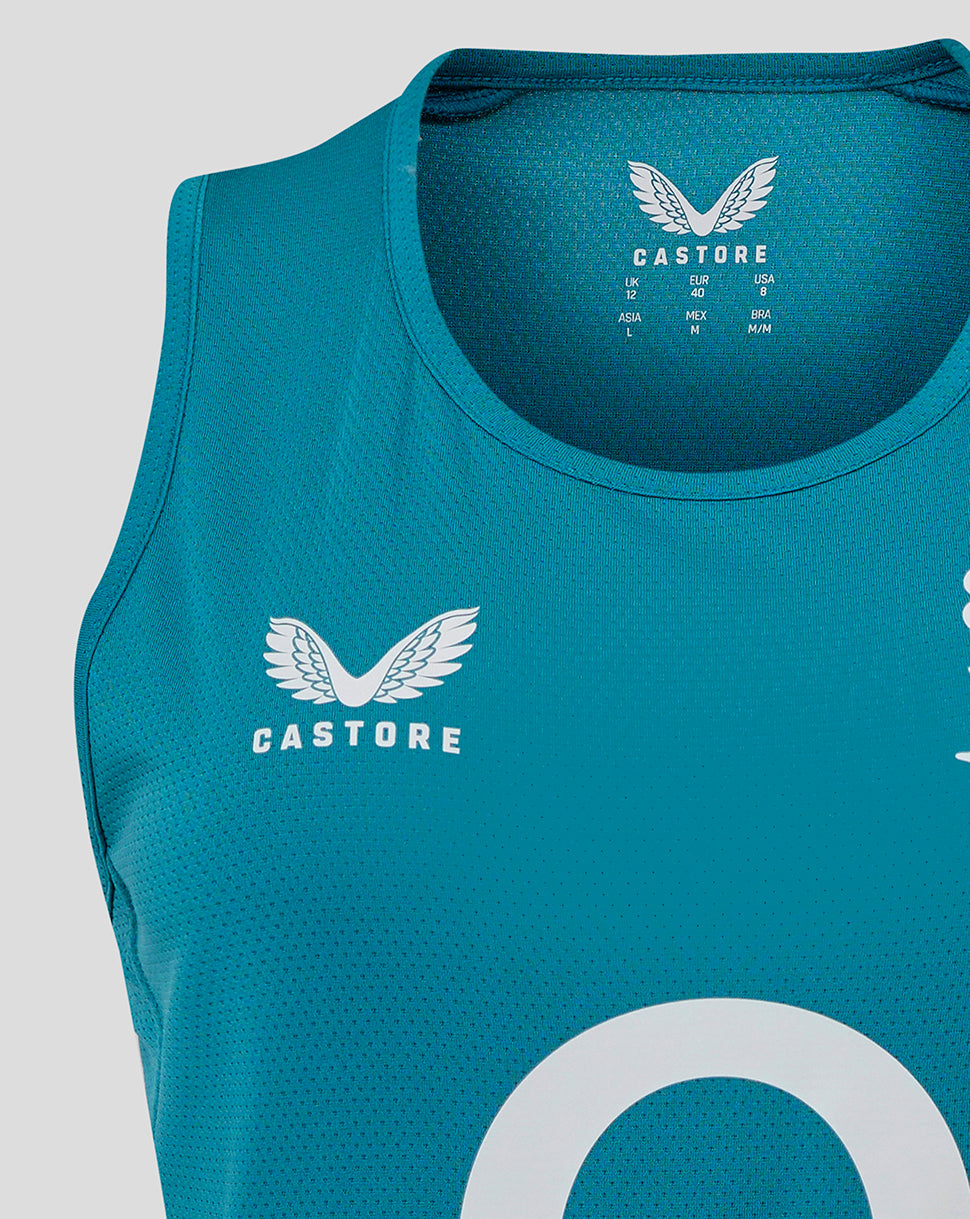 Chest close up of storm blue England Rugby Women’s sleeveless jersey showing white rose crest on left chest and Castore logo at the neck