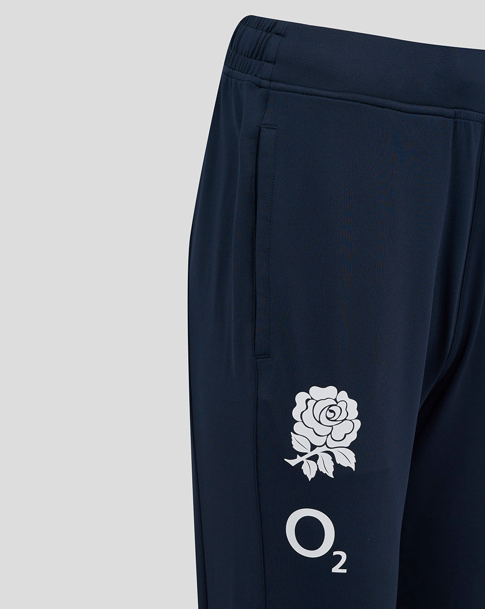 Back view of navy knit pants with elastic waistband and leg logos in white rose and O2