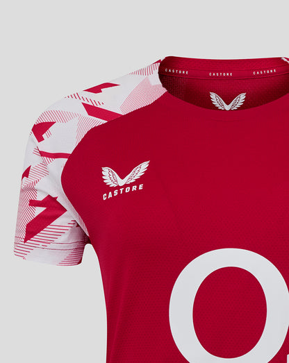 Close up of shoulder and chest showing white geometric sleeve print and Castore logo on red England Rugby shirt