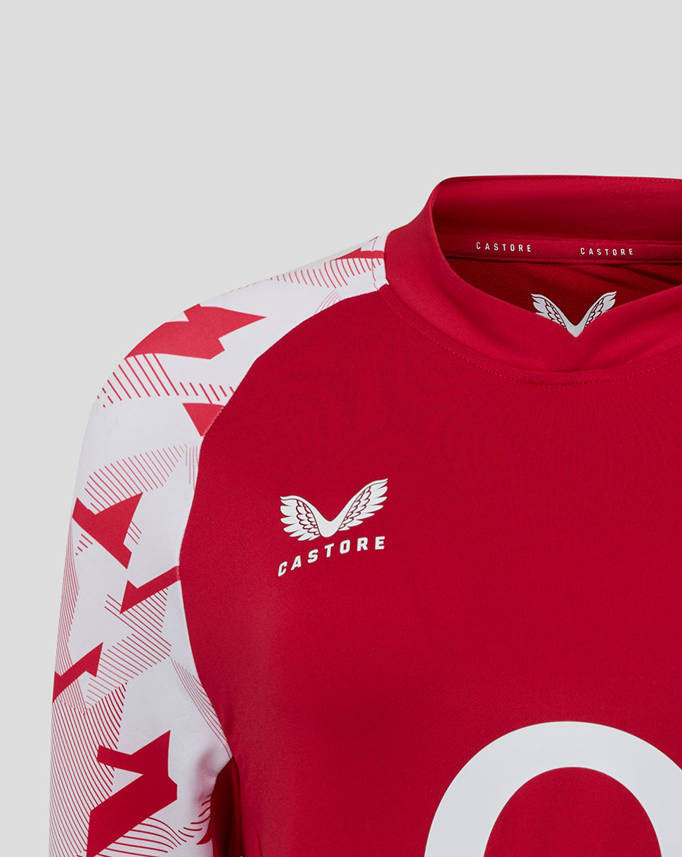 Close up of red England Rugby drill top with white geometric sleeves and the rose crest on the left chest