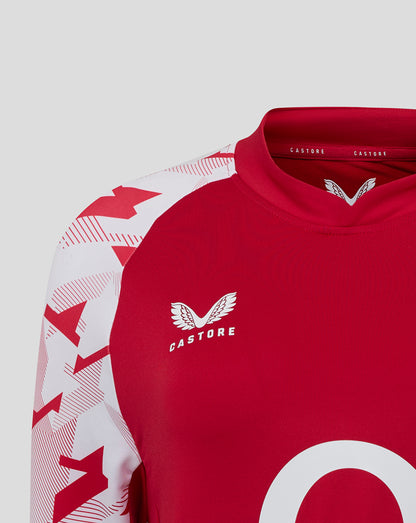 Close up of red England Rugby drill top with white geometric sleeves and the rose crest on the left chest