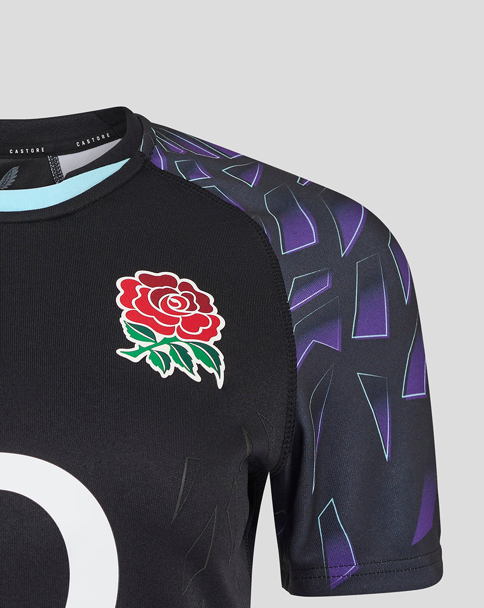Chest view of black rugby shirt showing red rose crest and large white graphic with purple patterned sleeves
