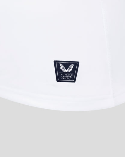 White fabric close up showing Castore authentic product badge near the hem