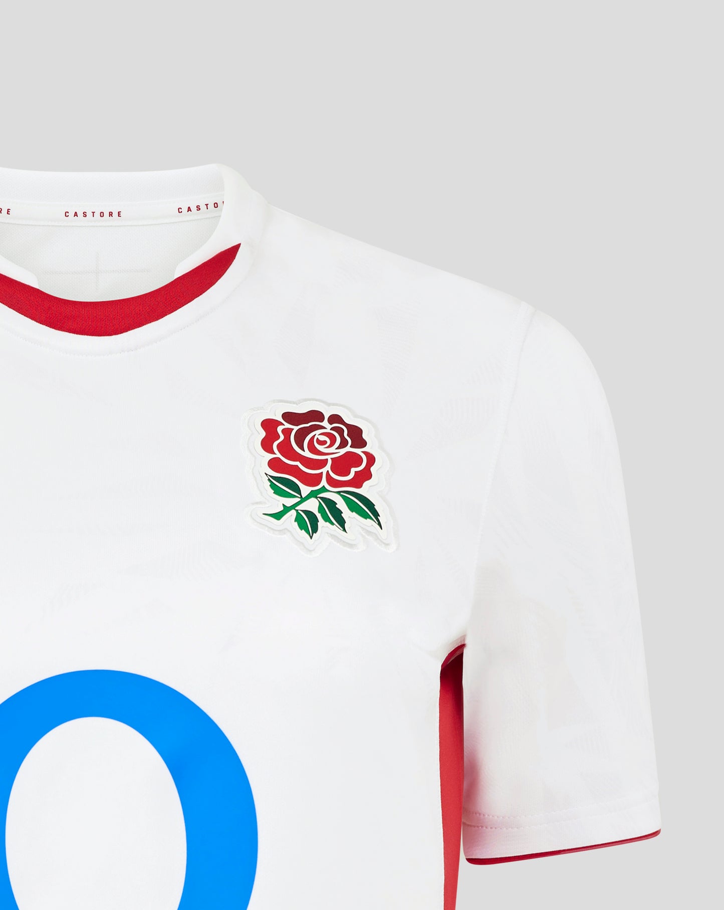 Close up of the white England Rugby home shirt neck area showing red trim inside the collar and a partial red rose crest on the chest